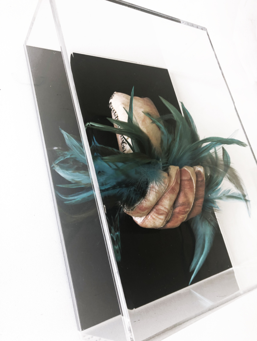 Elia Alba Judy (Study #3), 2019, Silk screen transfer on fabric, dyed rooster feathers, wire, poly-fil, zipper, acrylic, plexiglass, 7 × 10 × 4 in, 17.8 × 25.4 × 10.2 cm. Courtesy of Samsøñ.