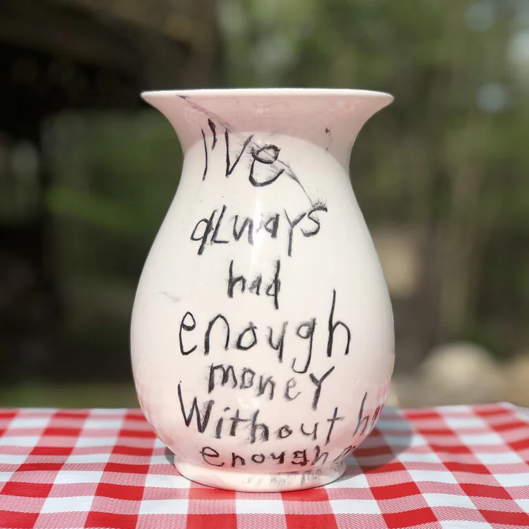 Cary Leibowitz, I’ve Always Had Enough Money Without Having Enough Money (2019-2020), Glaze crayon on ceramic vase , 8 x 5 x 5 in (20.3 x 12.7 x 12.7cm) . Courtesy of New Discretions and the artist.