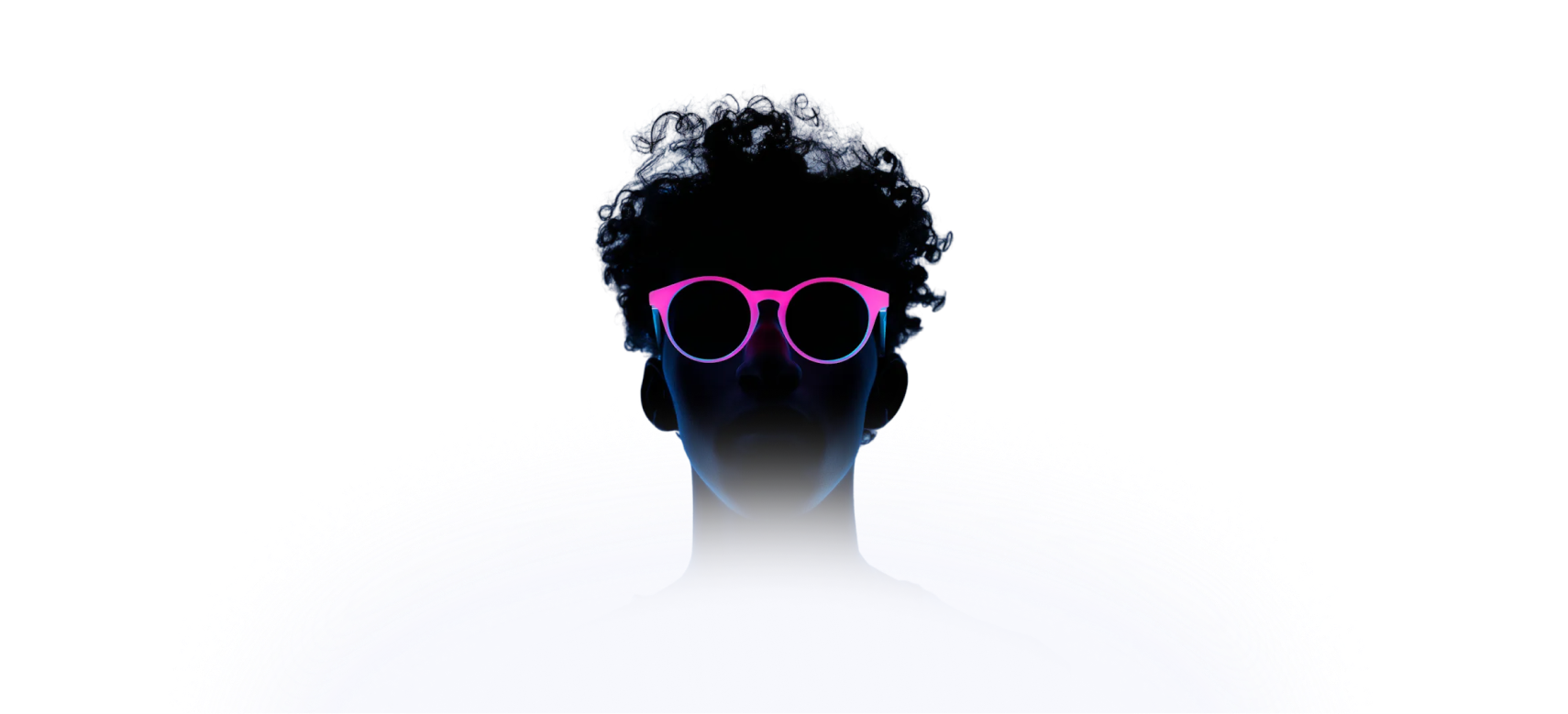 Silhouette of a person with curly hair wearing neon pink and blue glasses against a dark background.