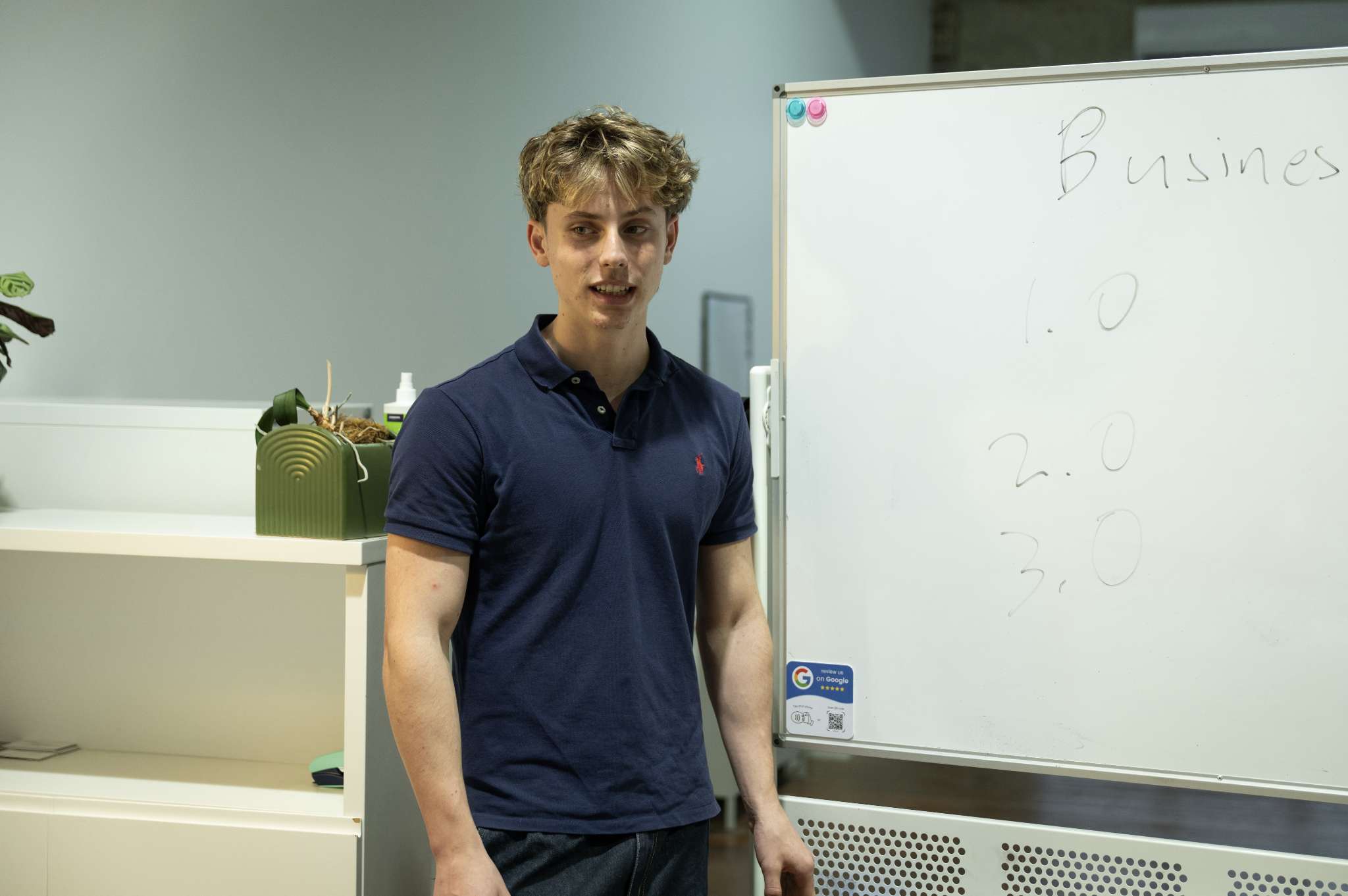 Maths tutor working through algebra on a whiteboard