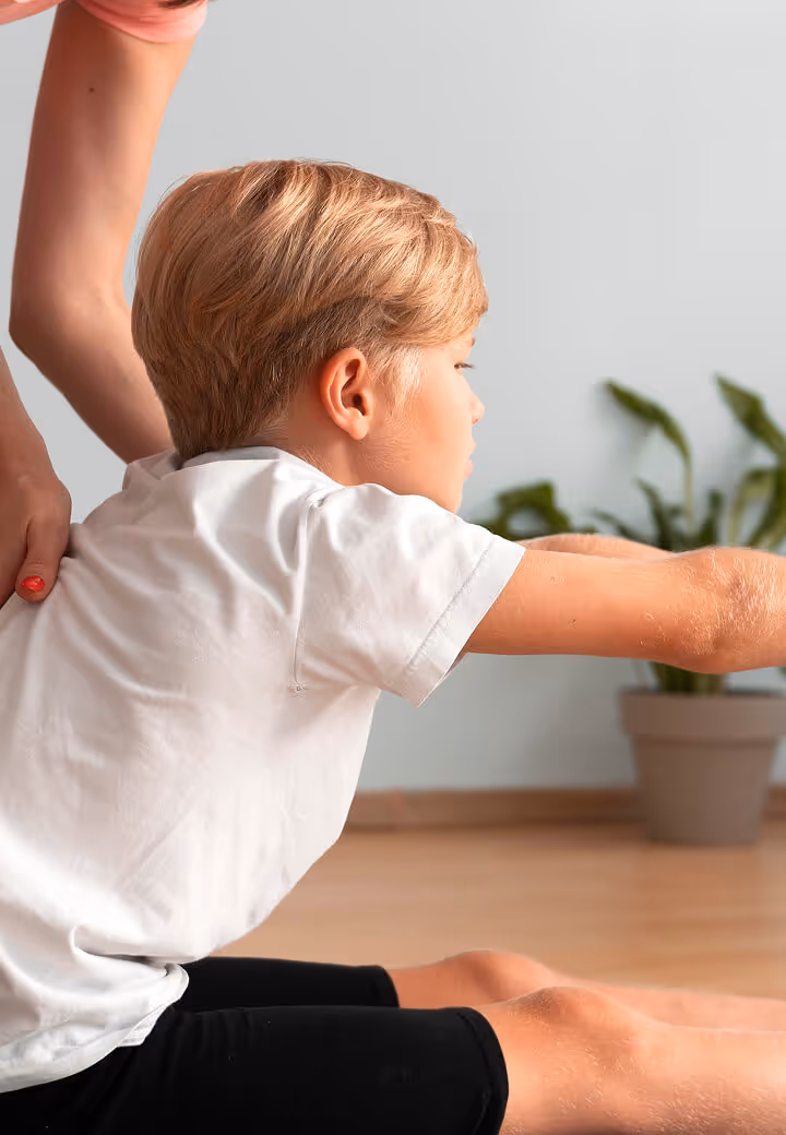 Child receiving gentle pediatric chiropractic stretching and mobility care
