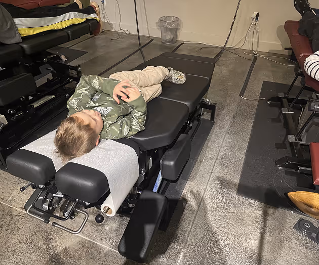 Pediatric chiropractic care session with gentle spinal adjustment for child at Thrive Wellness Center