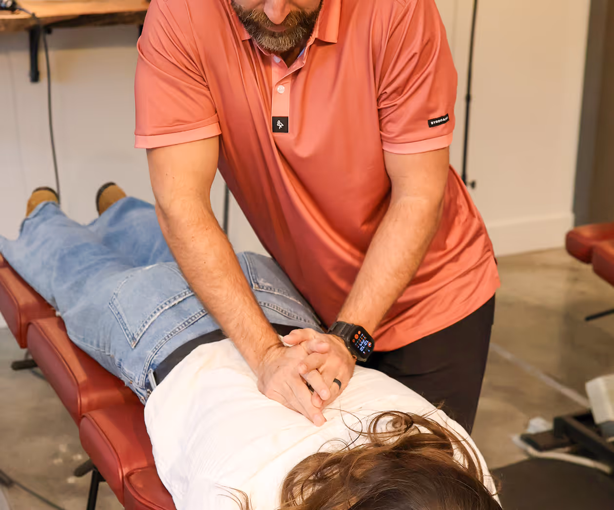 Chiropractor treating carpal tunnel syndrome with wrist and nerve assessment techniques