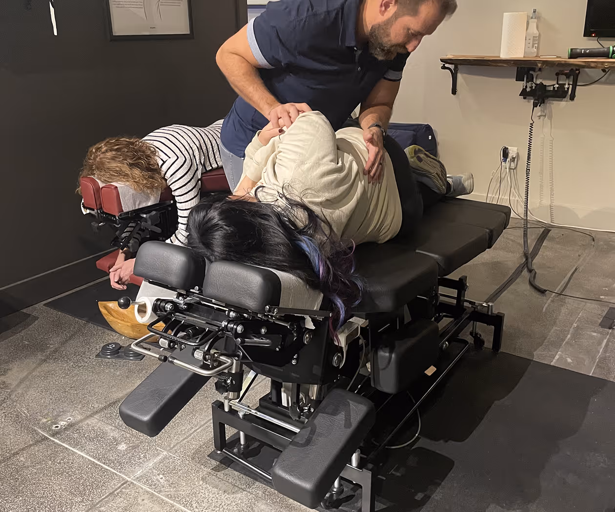 Chiropractor performing spinal assessment for lower back pain and lumbar discomfort