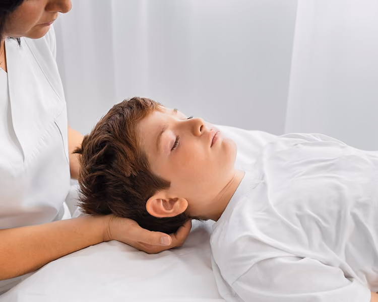 Chiropractor using gentle age-appropriate techniques for safe pediatric chiropractic care