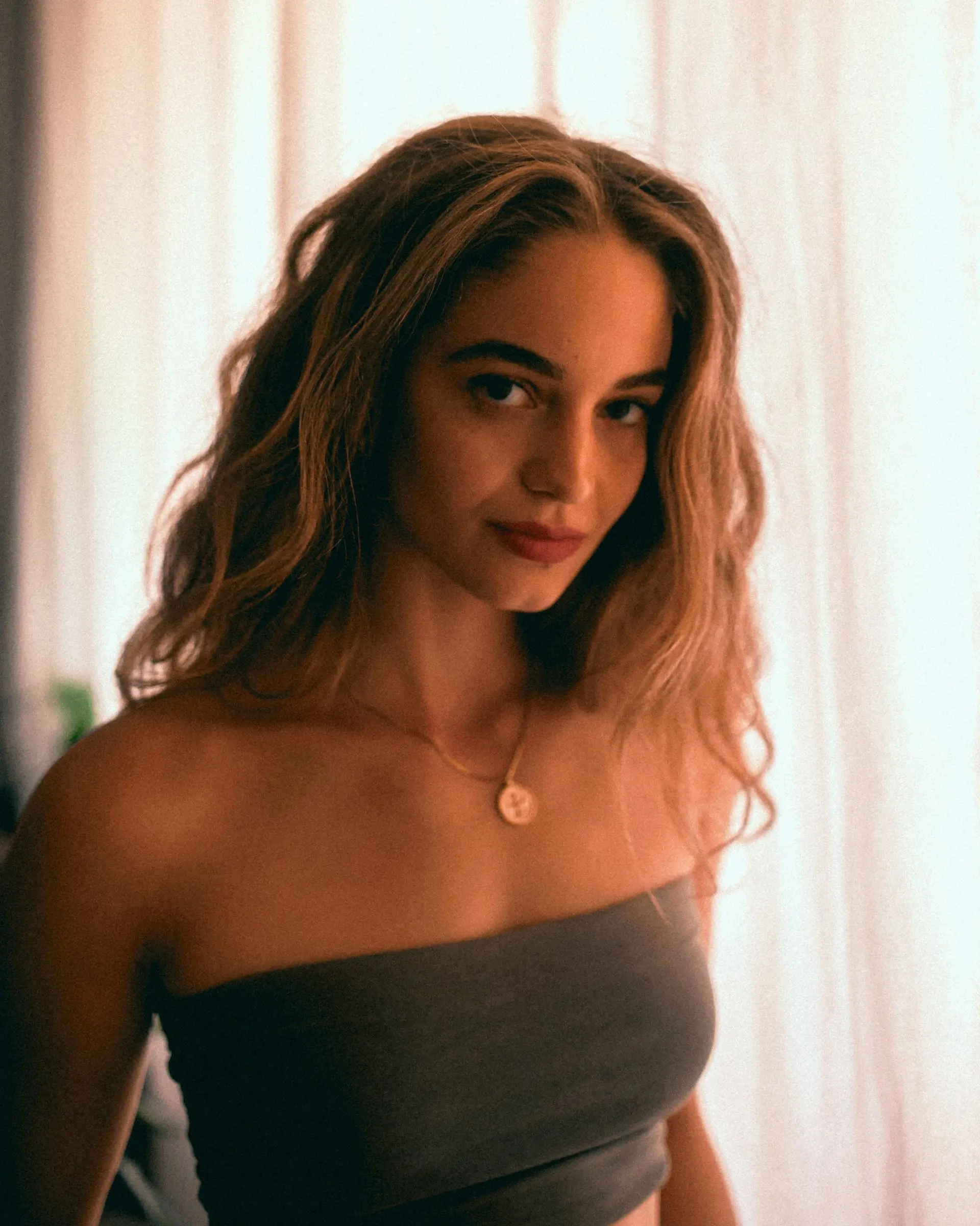 Woman with wavy brown hair, and red lipstick