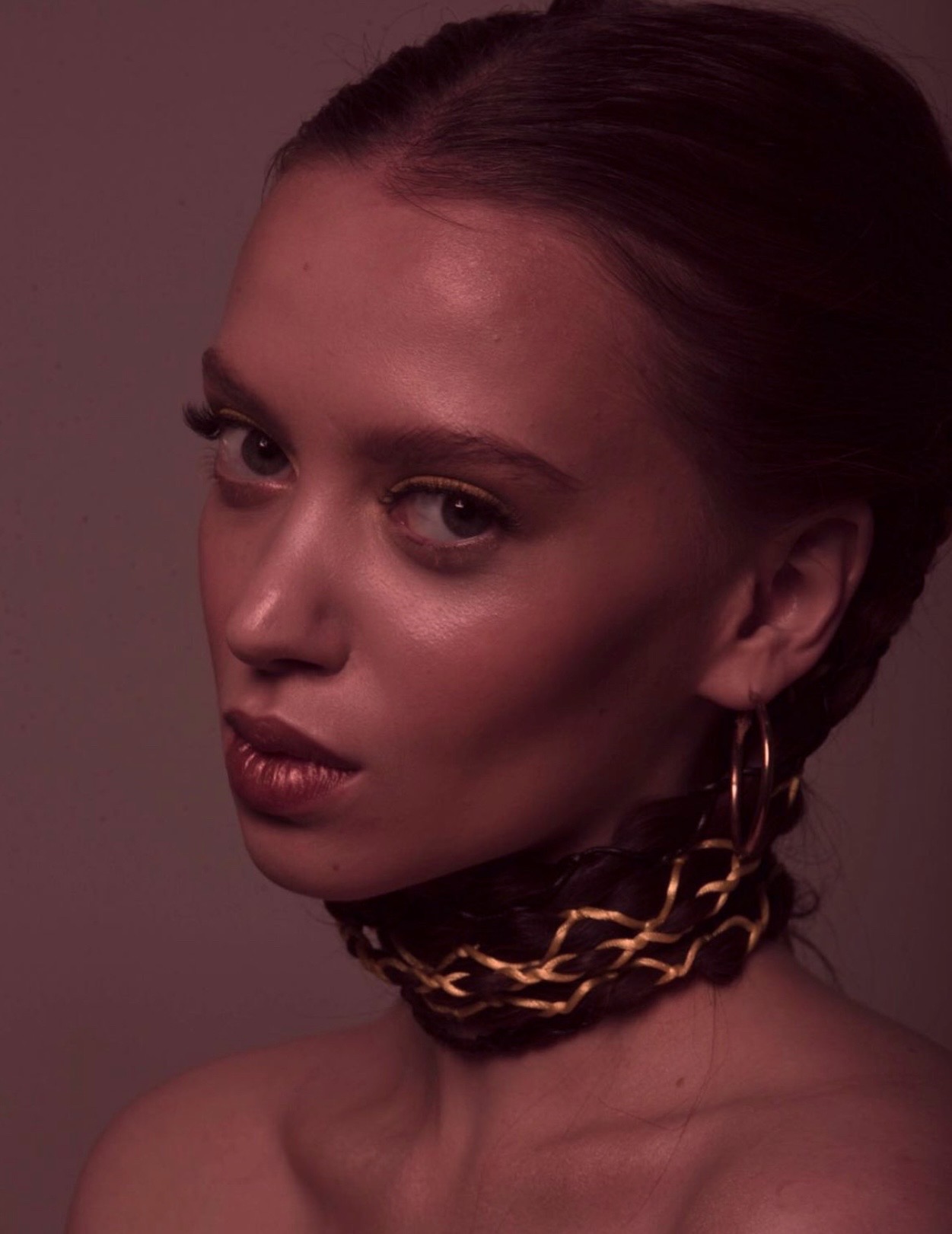 Woman wearing neckless, in grayscale, looking thoughtfu