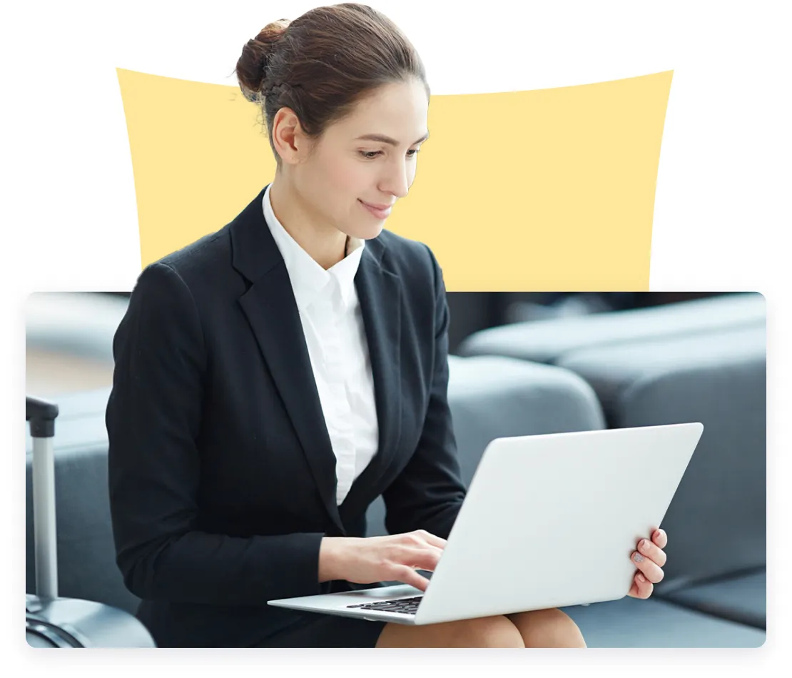 A woman in a black blazer and white shirt focused on typing on a laptop, with a yellow triangular background element.