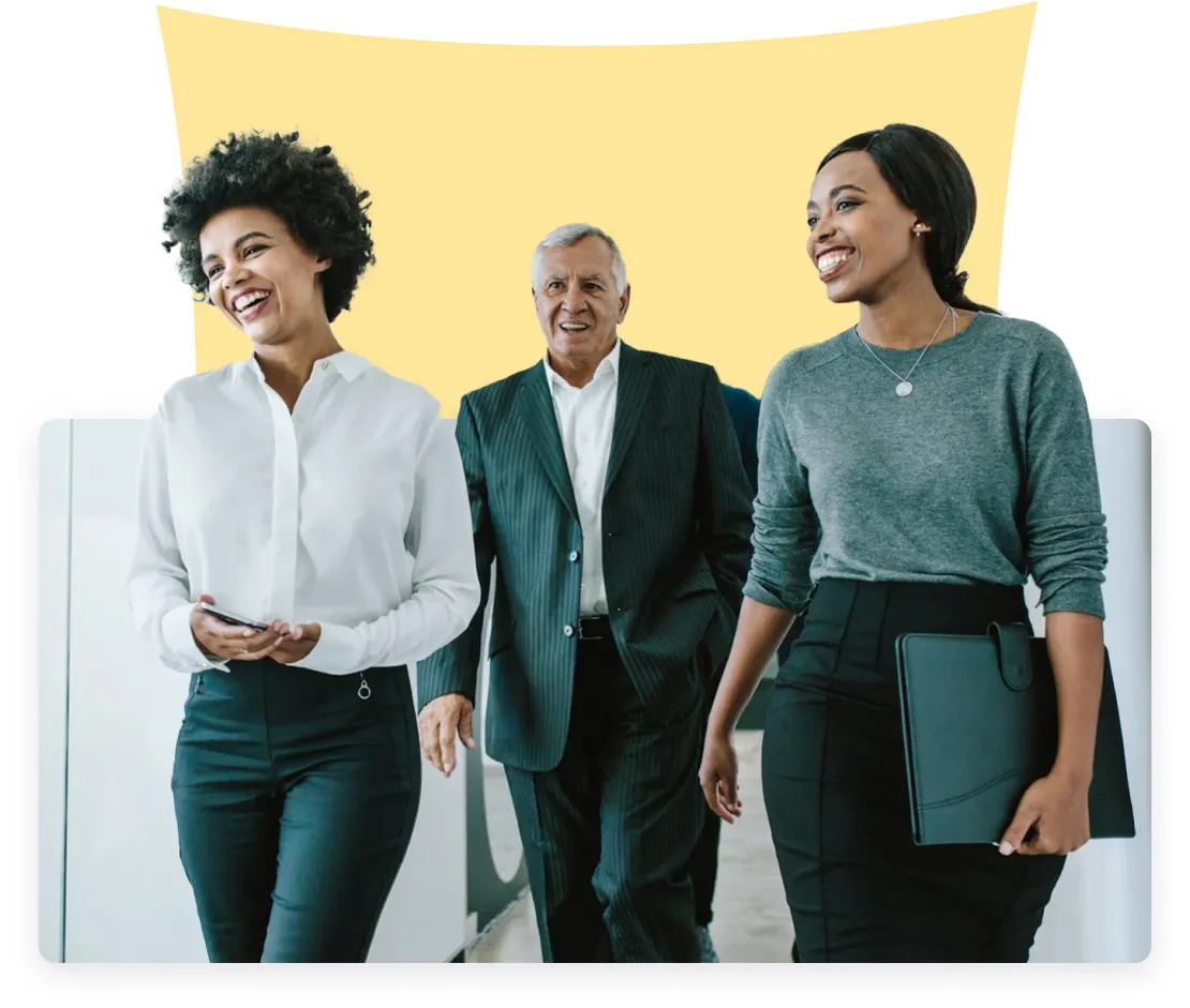 Three professionals walking together: A woman with curly hair and a white blouse holding a smartphone, an older man in a dark suit, and another woman in a grey sweater carrying a black folder, all against a bright yellow background.