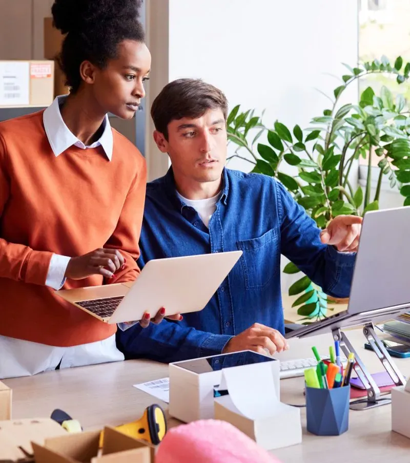 Two coworkers collaborate in an office using Disclo platform features.