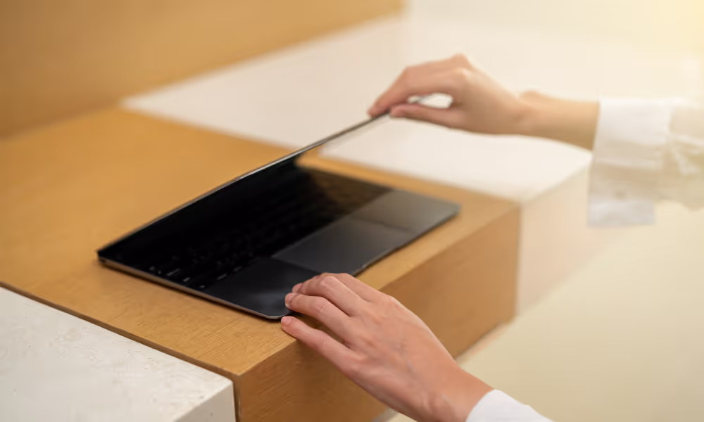 Woman's hands shutting a laptop