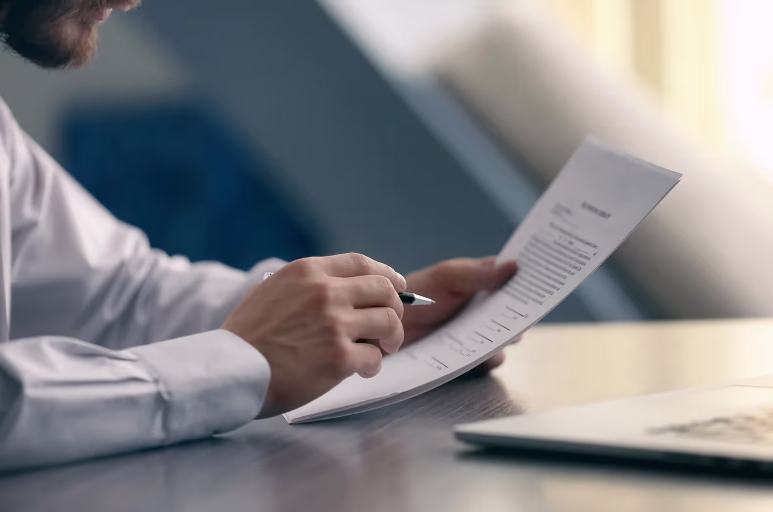 Image of someone reviewing documents at a desk.
