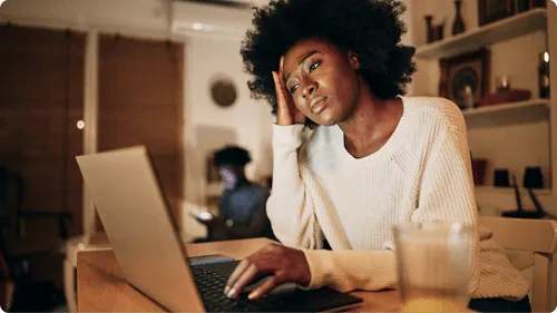 Person looking concerningly at their computer.