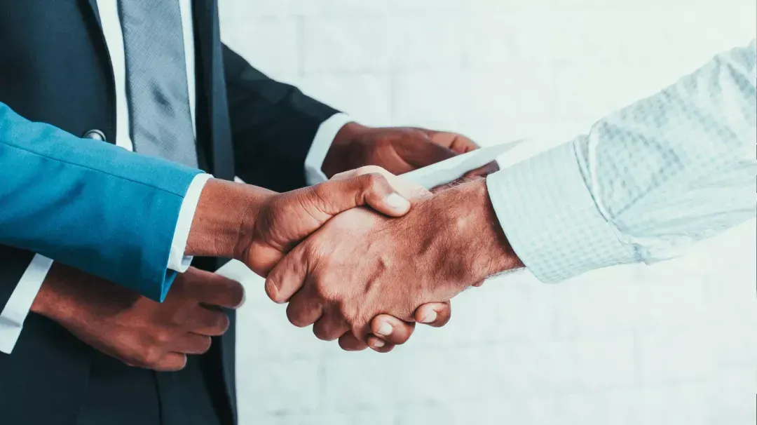 Two people shaking hands.