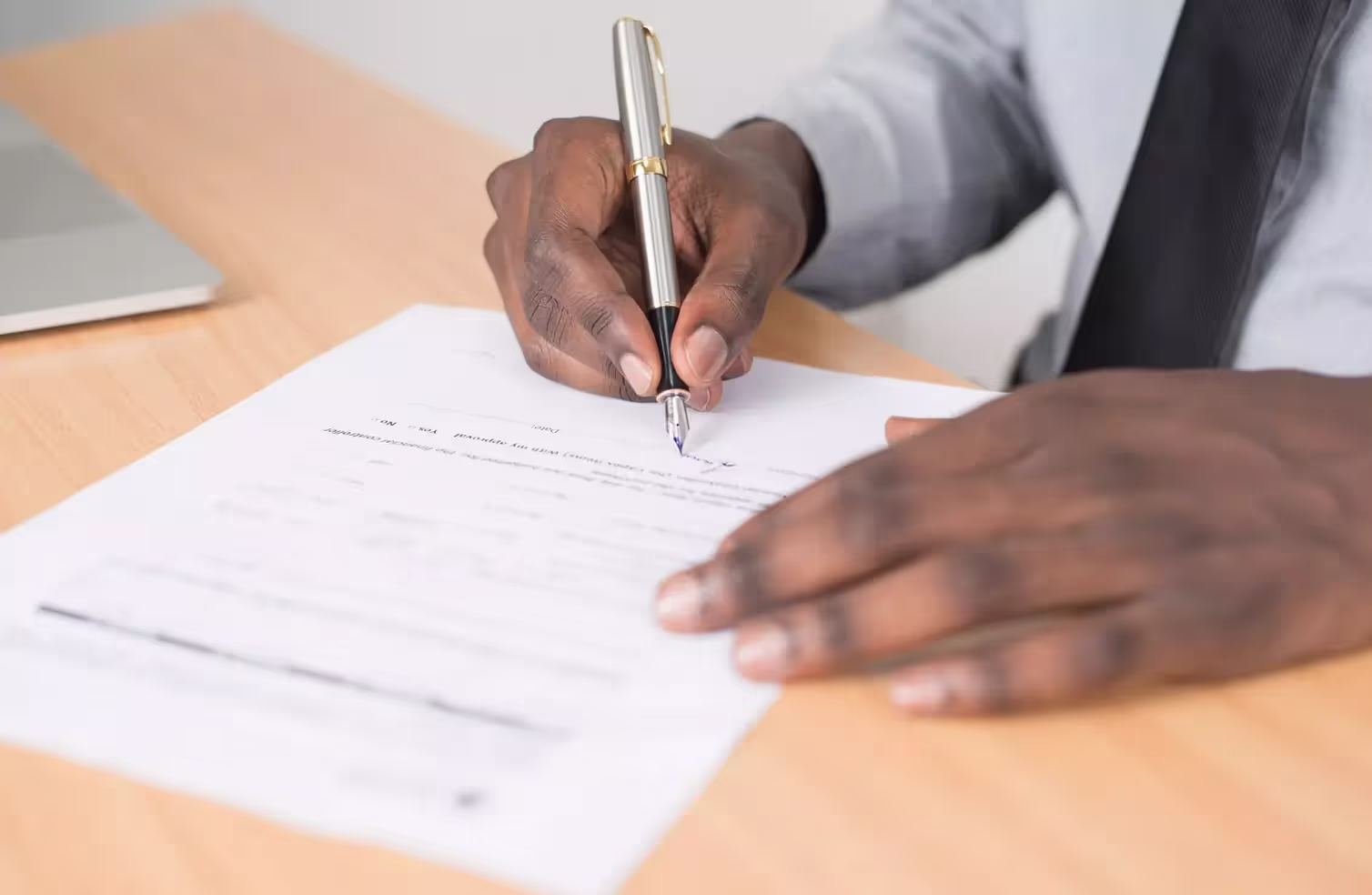 A person signing a form.