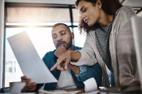 Two people looking at a document.