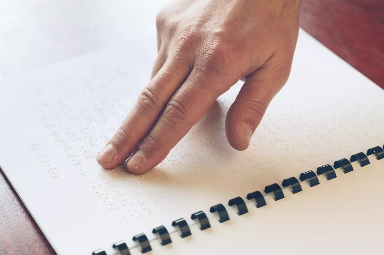 Fingers running over braille.