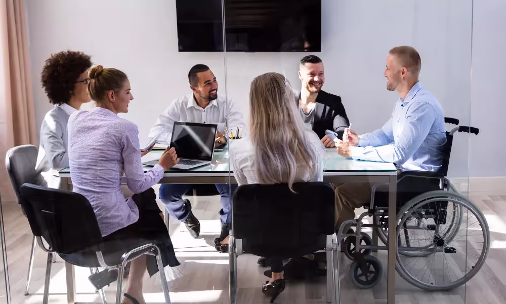 Group of diverse employees sitting around a table in an office.