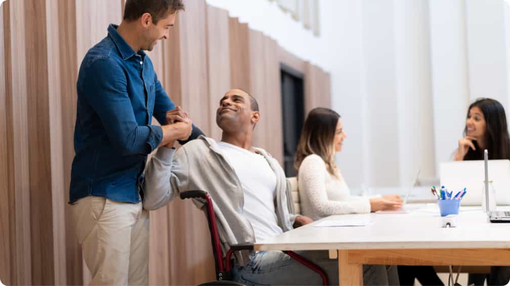 Two co-workers shaking hands after a meeting.