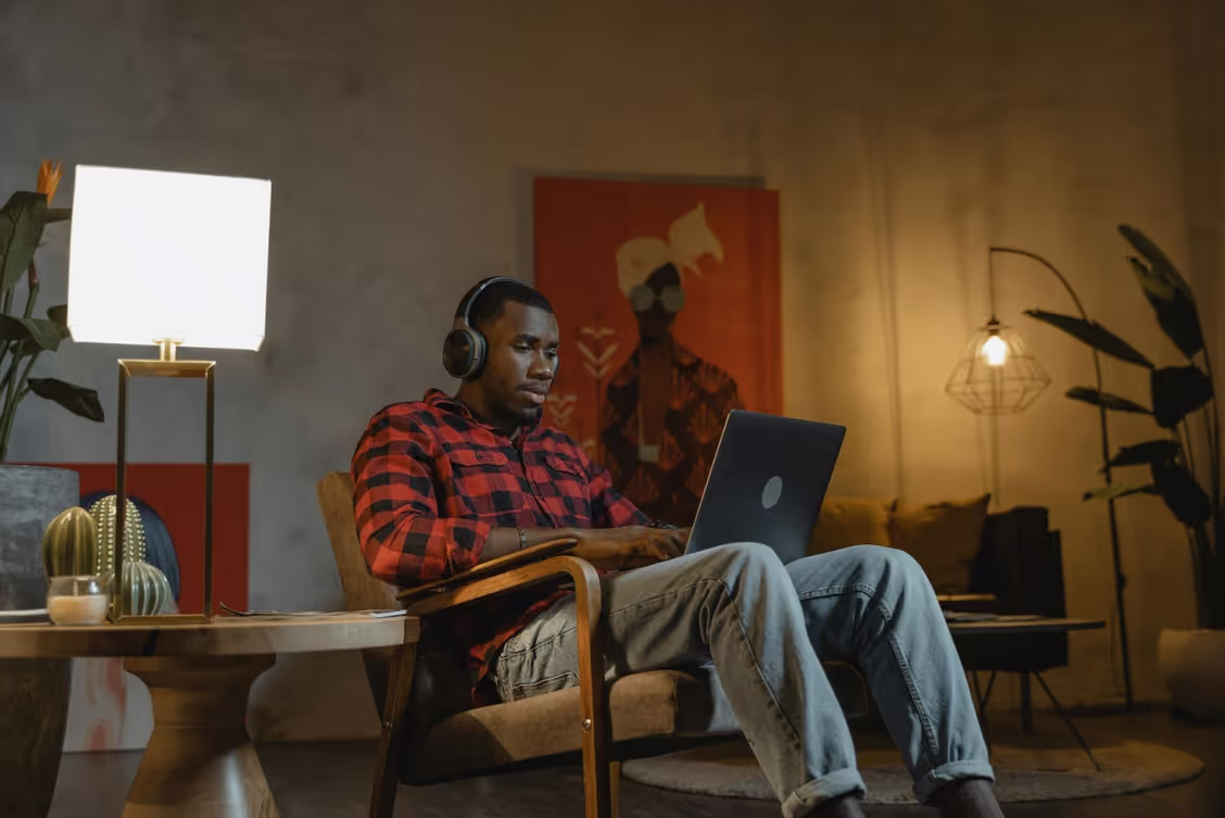 Person working on laptop at home.