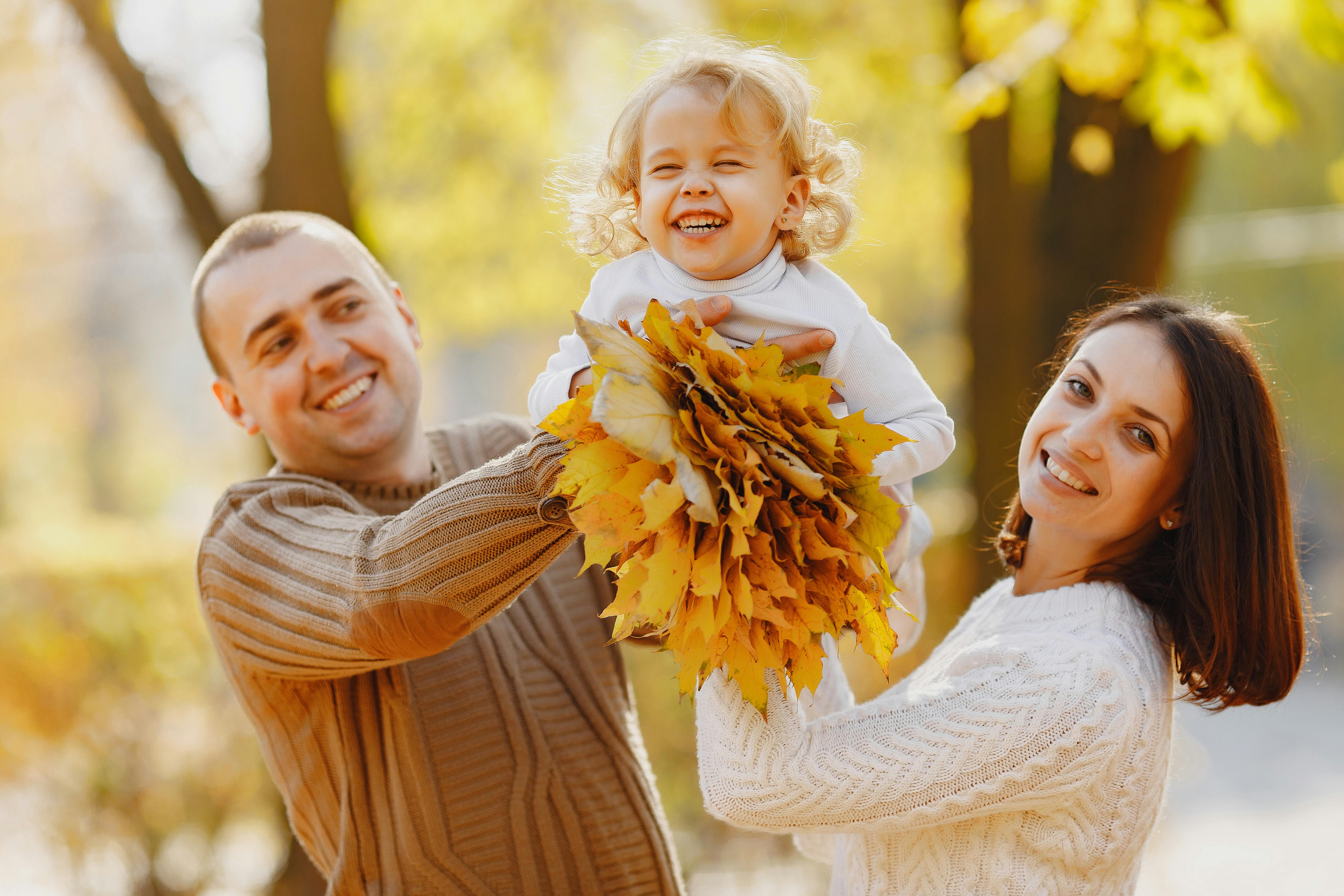 A happy family among Autumn trees.