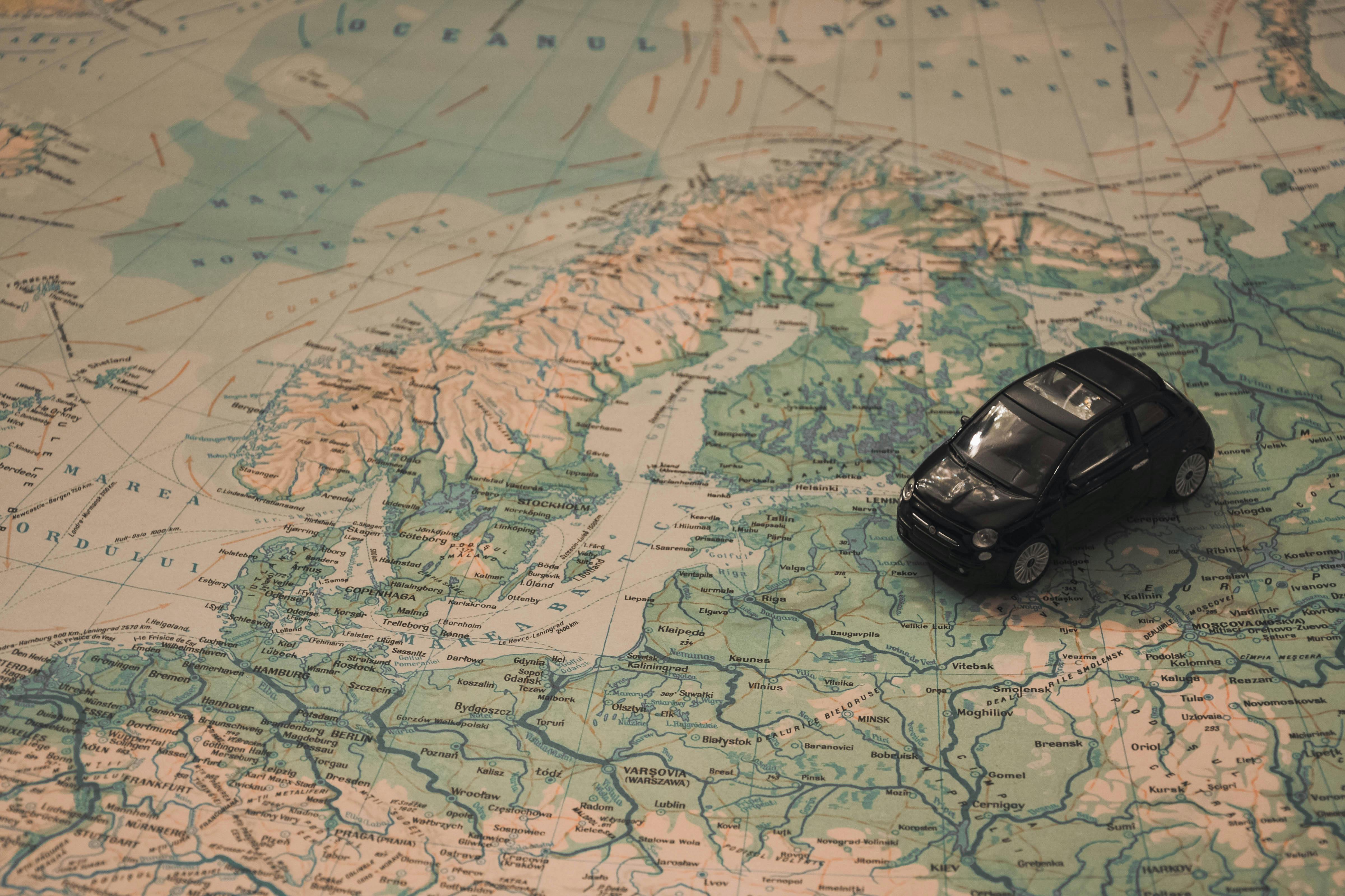Toy car atop a global map. 