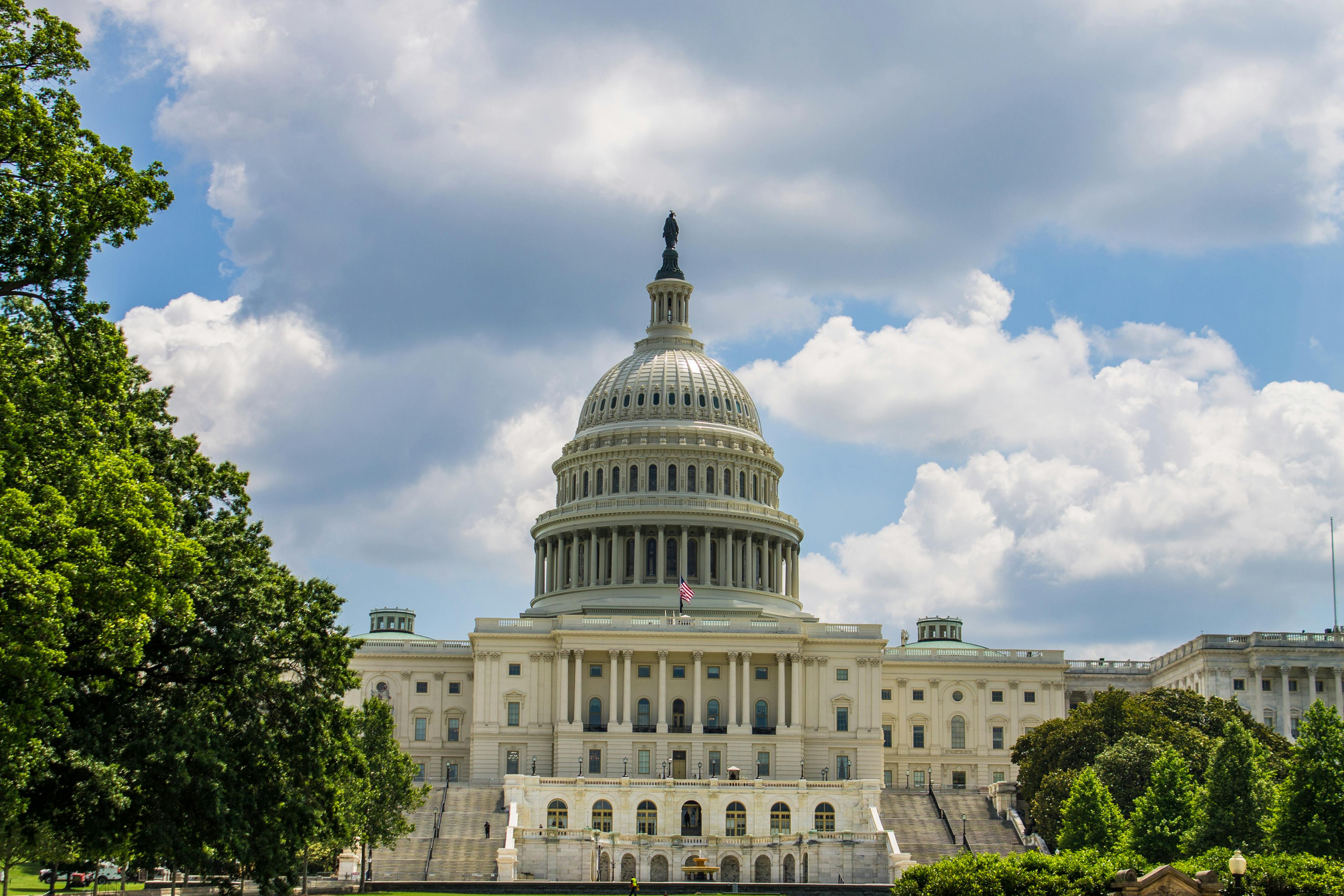 The U.S. Capitol building under a blue sky.