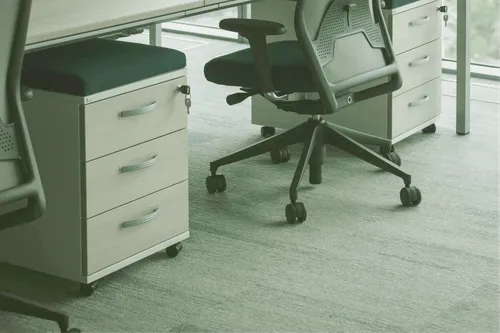 An ergonomic office chair pushed into a desk.