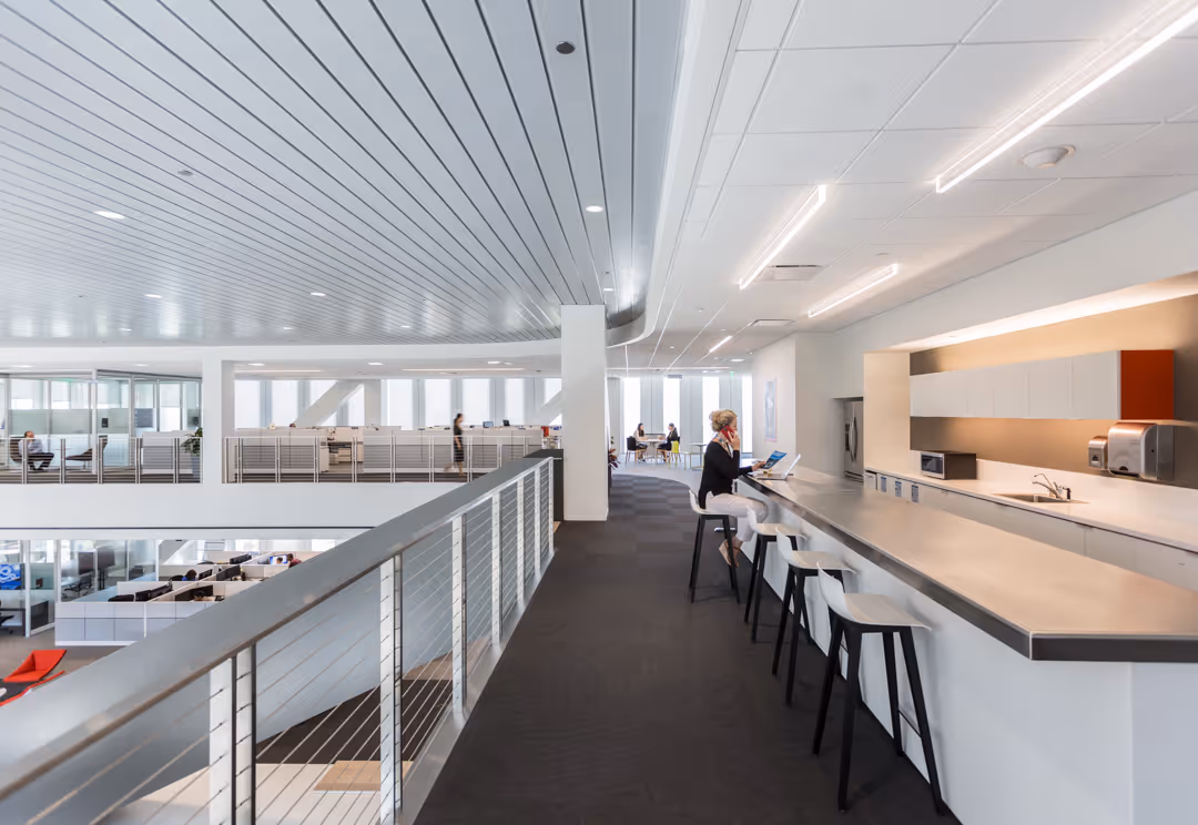 A red Disclonaut character smiling and using a laptop with a star sticker against a yellow background. Beside it, an open software window titled 'All cases' displays a list of cases with employee names, requests, case managers, and status (such as 'Waiting for your action', 'Approved', 'Follow-up', and 'Denied'). Decorative yellow stars are scattered around the scene.