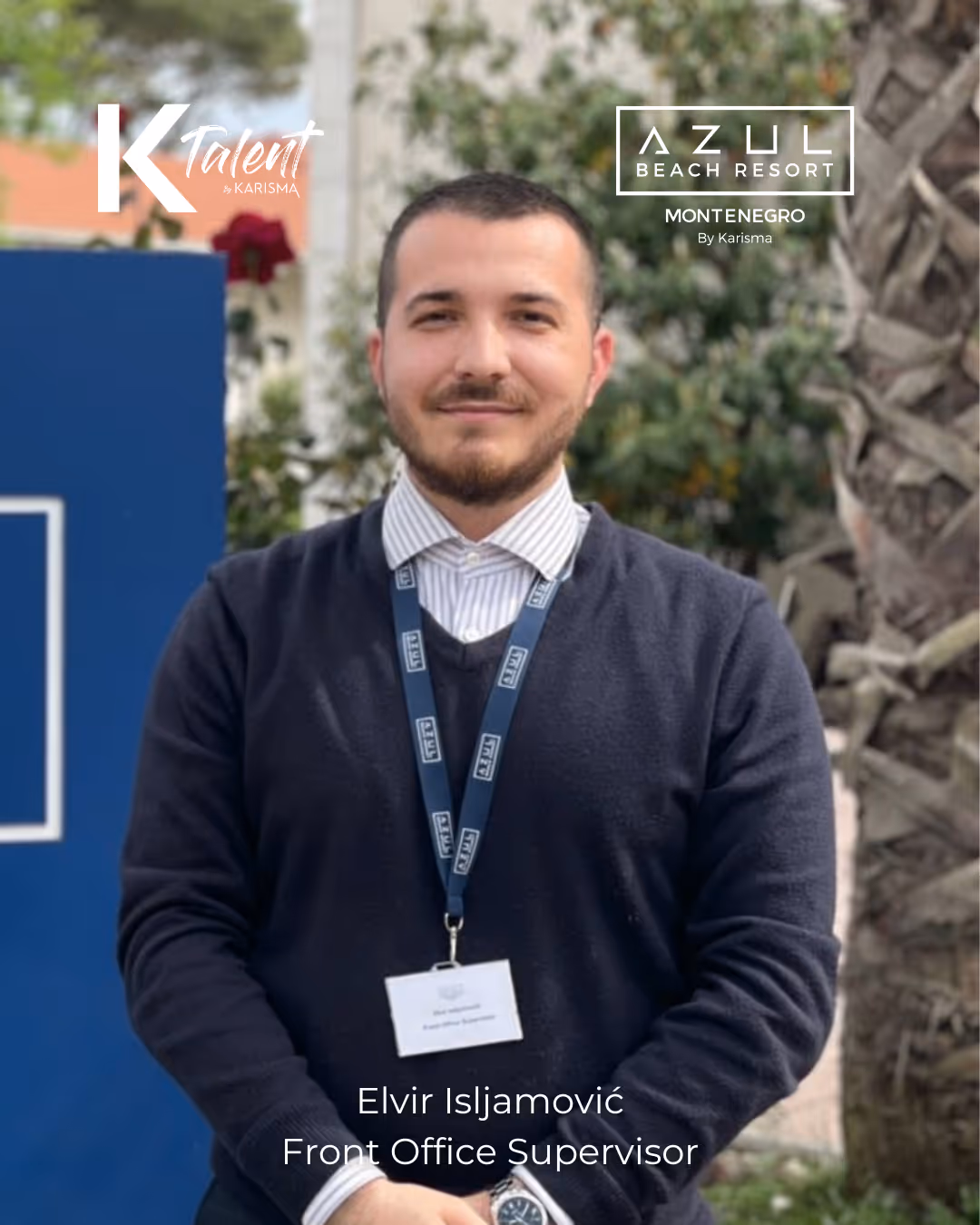 Portrait of Elvir Isljamović, Front Office Supervisor, standing outdoors wearing a navy sweater and striped shirt with a lanyard badge.