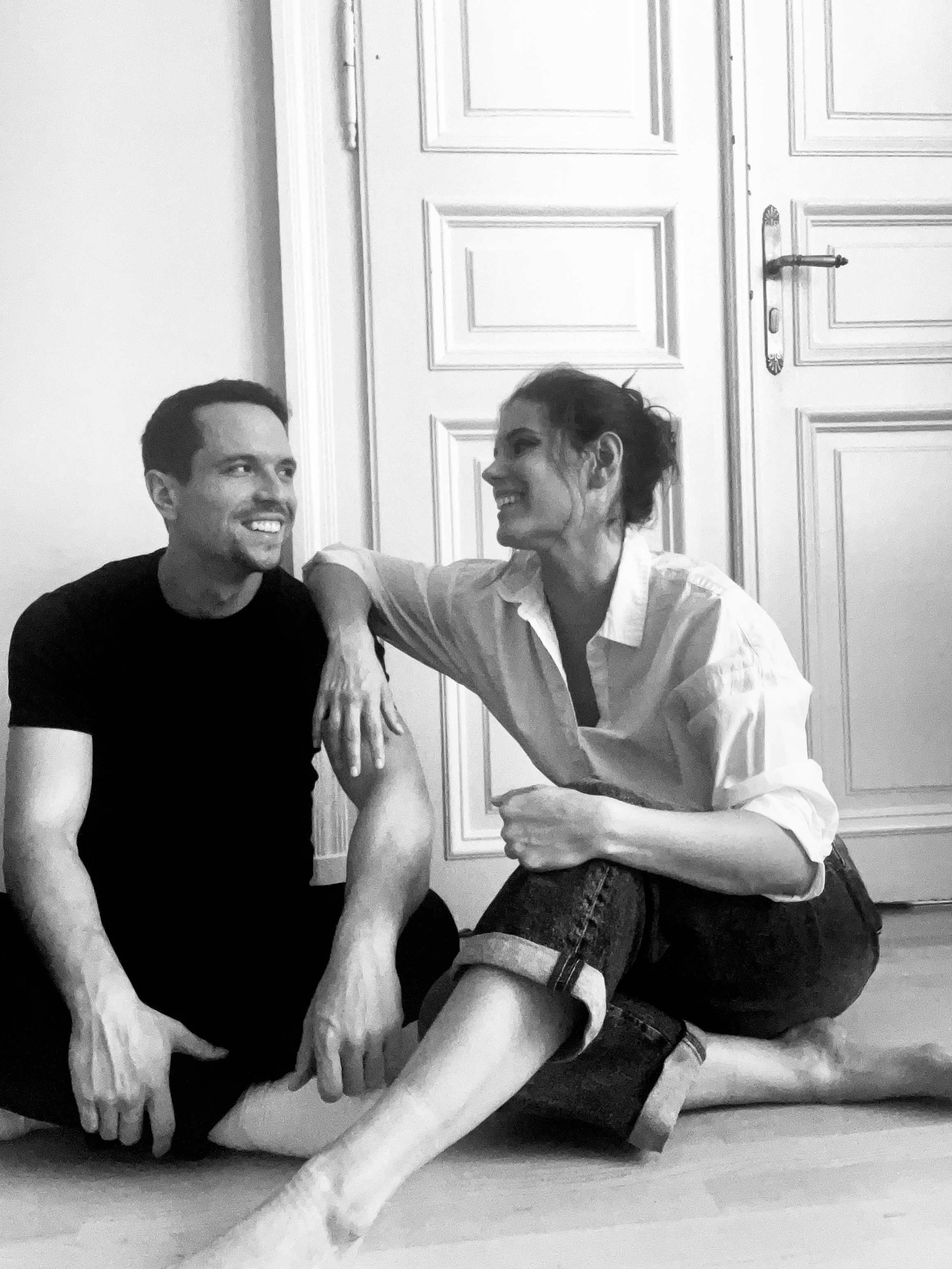 Reka Szijj and Mike Vitez, founders of Saturnia Design, sitting and smiling.