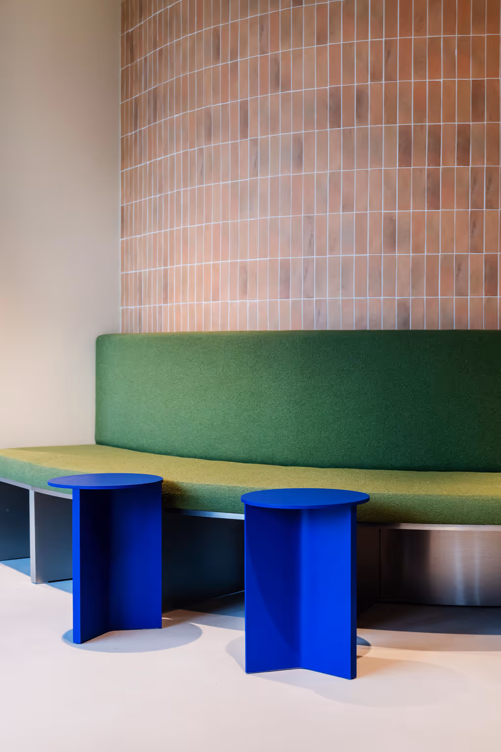 Hands holding and pointing to colorful Lumina Learning personality cards and a personality traits wheel on a white table.
