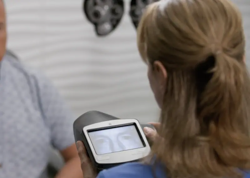 Still image from https://3dassets.hillrom.com/content2/FLC-Vision-SVS_Calabrese-27.mp4 showing use of a Welch Allyn Spot Vision screener