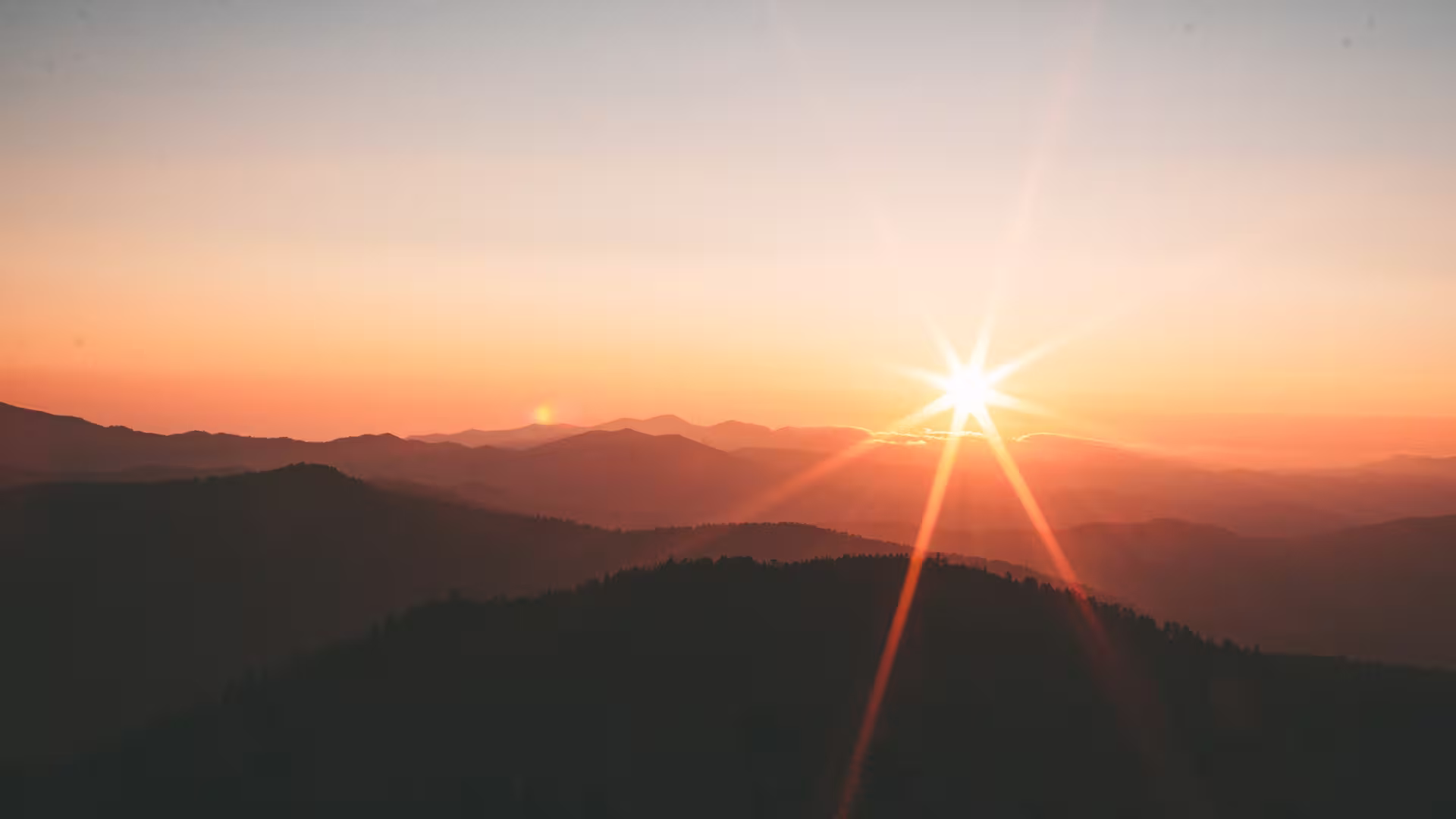 Sunset over mountains with light rays — natural landscape, preserved environment and mountain biodiversity