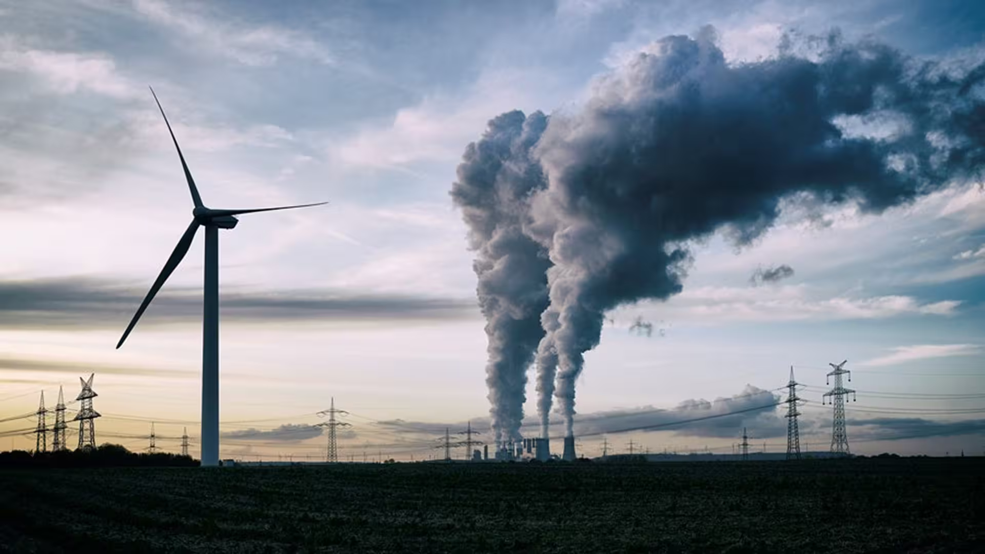 Factory with pollution and wind turbines — energy transition and reduction of industrial environmental impact