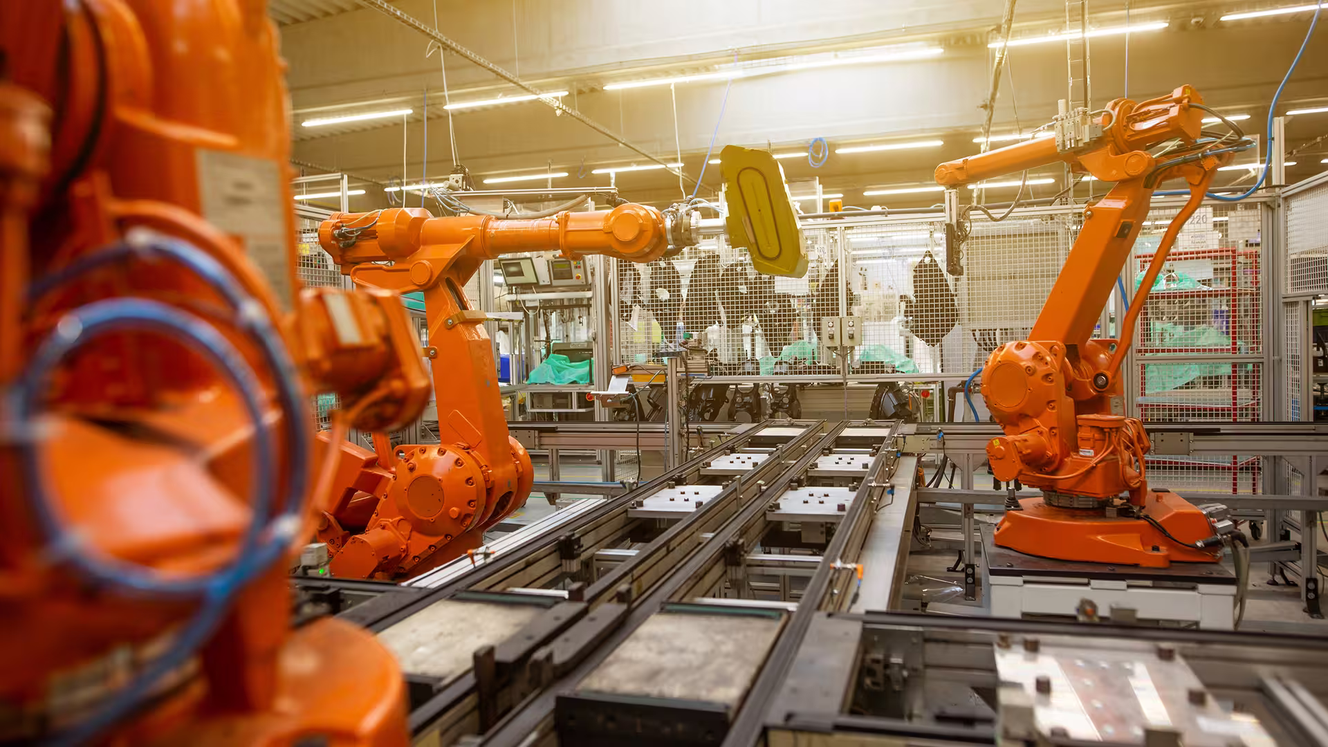 Robotic arms in action in an automated manufacturing plant, illustration for Life Cycle Analysis