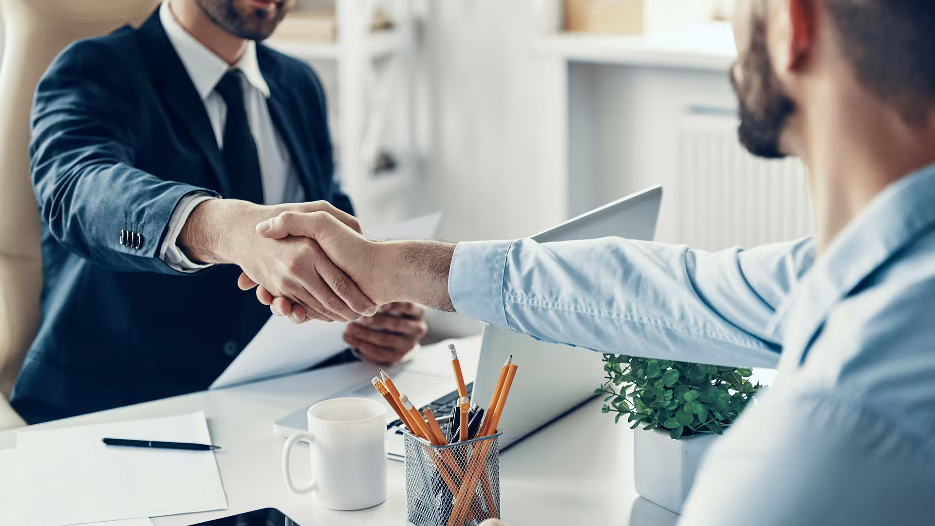 Professional handshake sealing a deal in an office, illustration for Public Assistance HR & Training