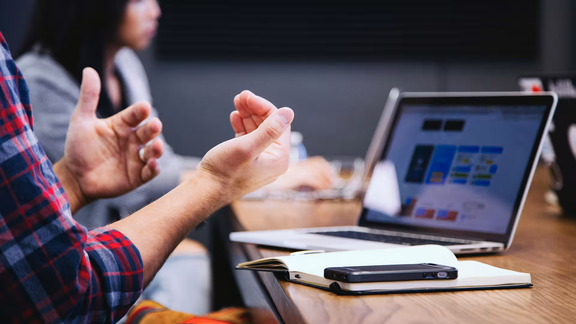 Professional discussion over a laptop during a meeting