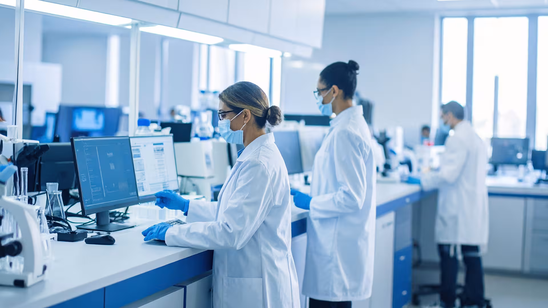Researchers working in a modern laboratory on scientific analyses