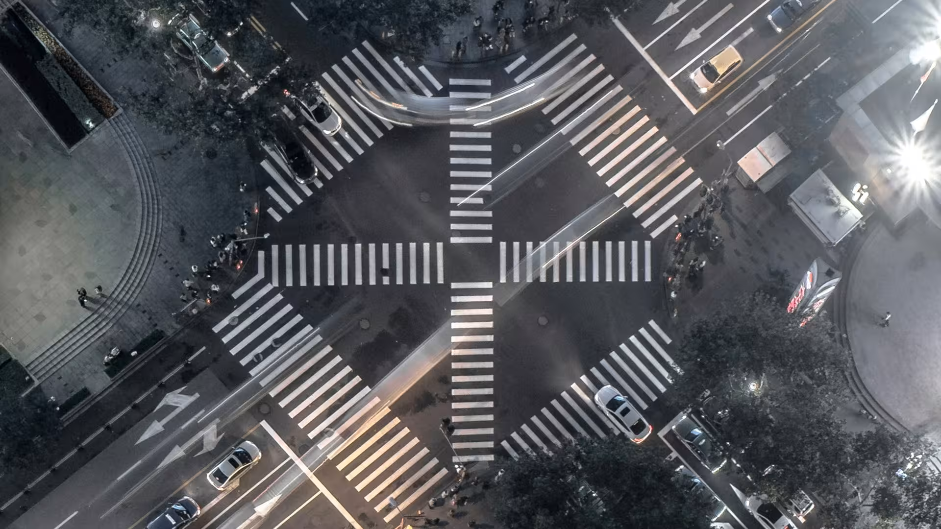 Night aerial view of an intersection with illuminated pedestrian crossings