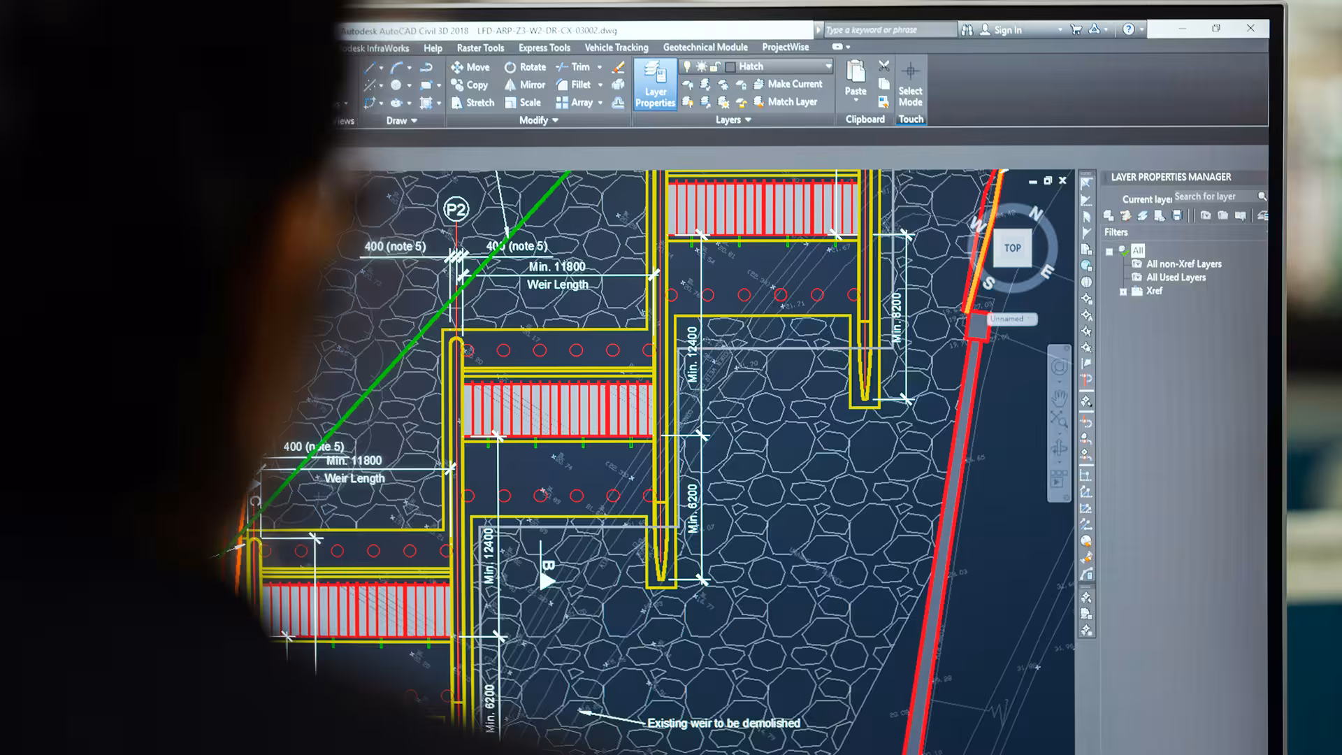 Engineer working on a CAD plan displayed on his computer screen