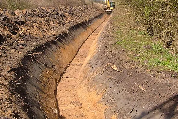 An image showing a well dug ditch preparing for drain pipes