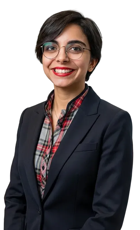Smiling woman with short dark hair wearing glasses, a plaid shirt, and a dark blazer.