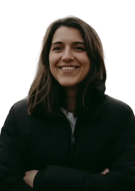 Smiling woman with dark hair wearing a black zip-up jacket with arms crossed.