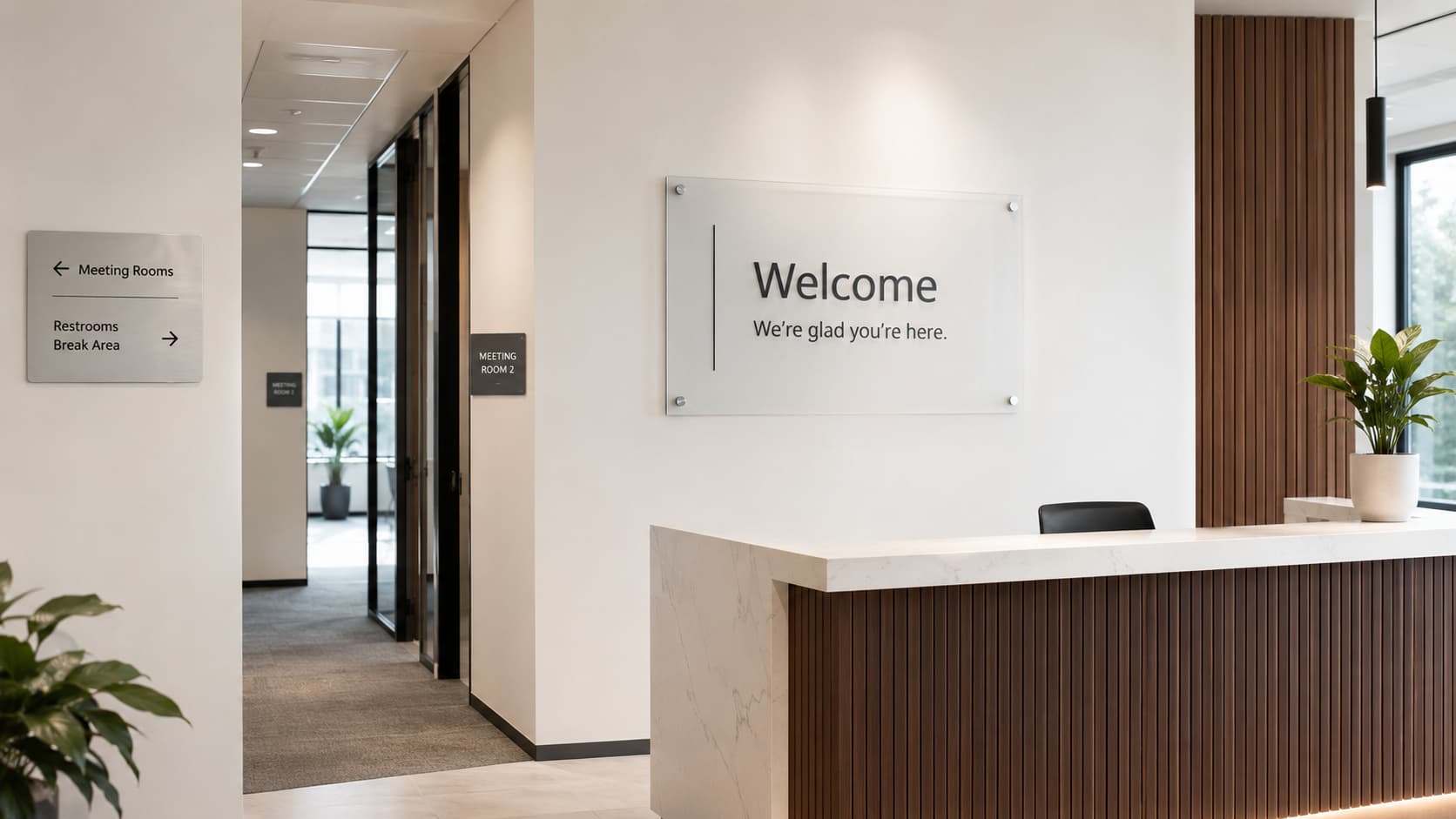 Modern office reception with wall-mounted signage and directional wayfinding signs.