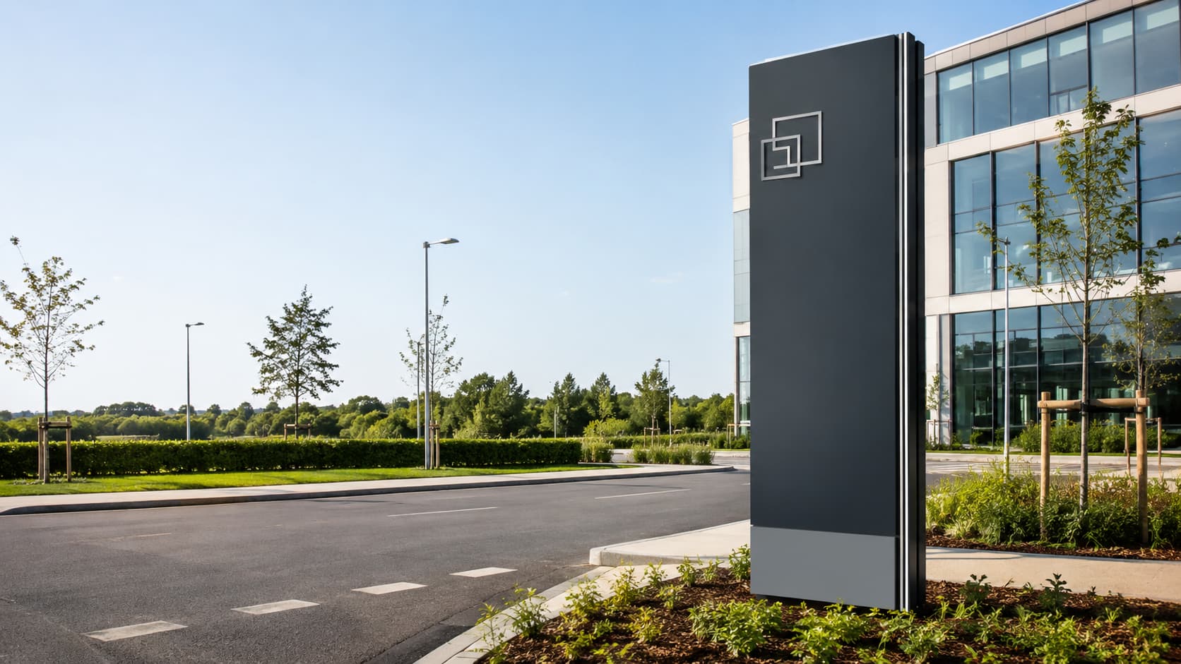 Modern freestanding monolith sign outside a contemporary business park.