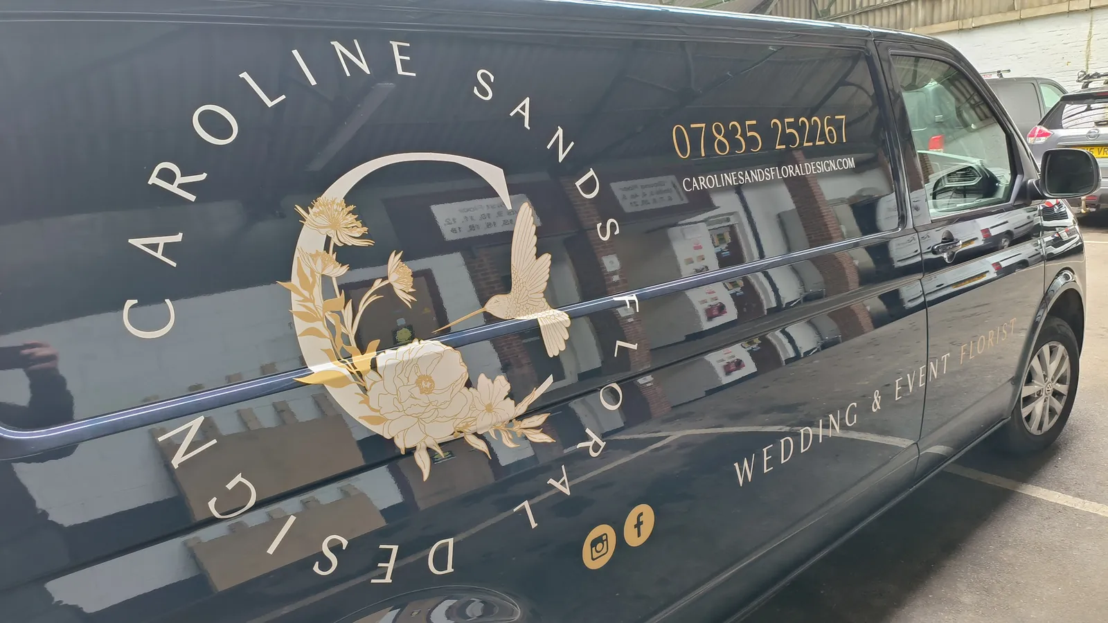 Gold vinyl graphics on a black van