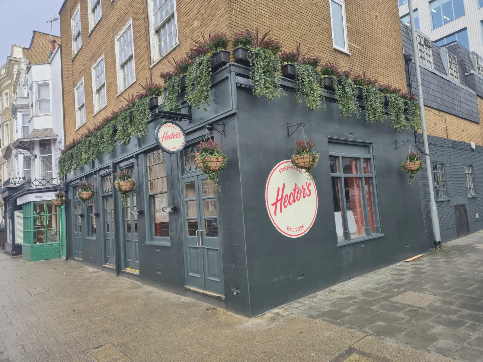 Hector's round projecting signs on a corner building