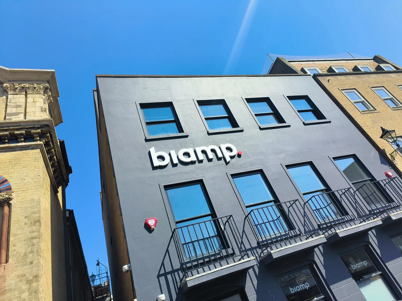 Biamp lettering on a dark building facade