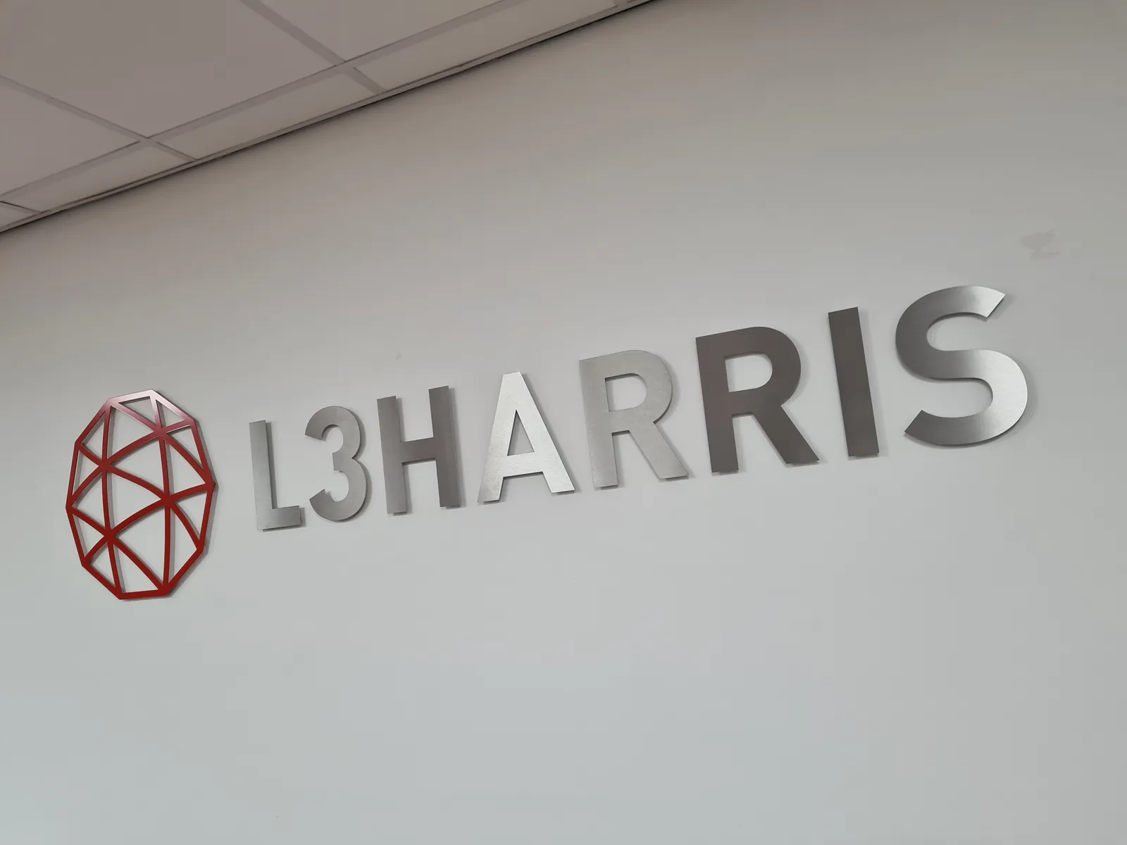 L3Harris logo on an office wall